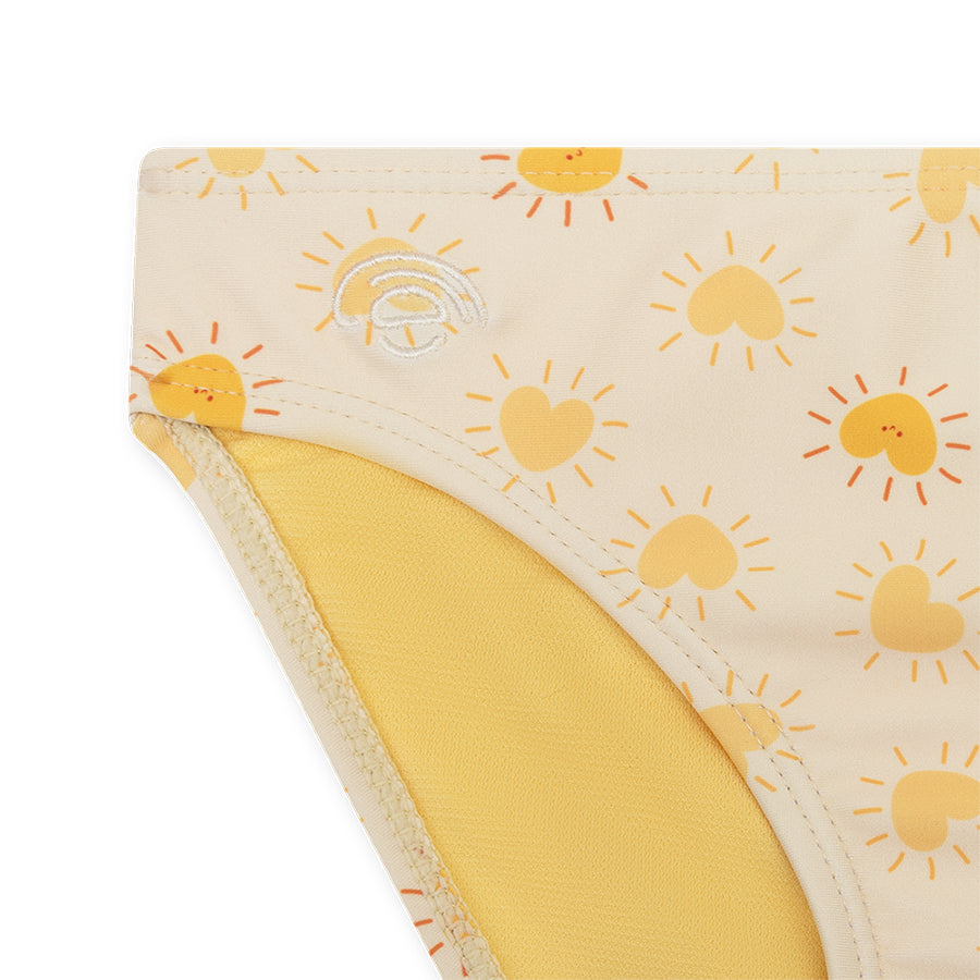 Close-up of a bikini bottom with sun pattern on a white background