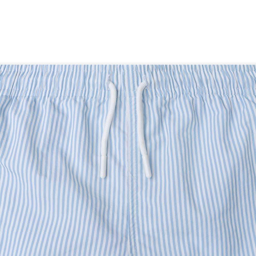 Close-up of blue and white striped swim short with drawstrings on a white background