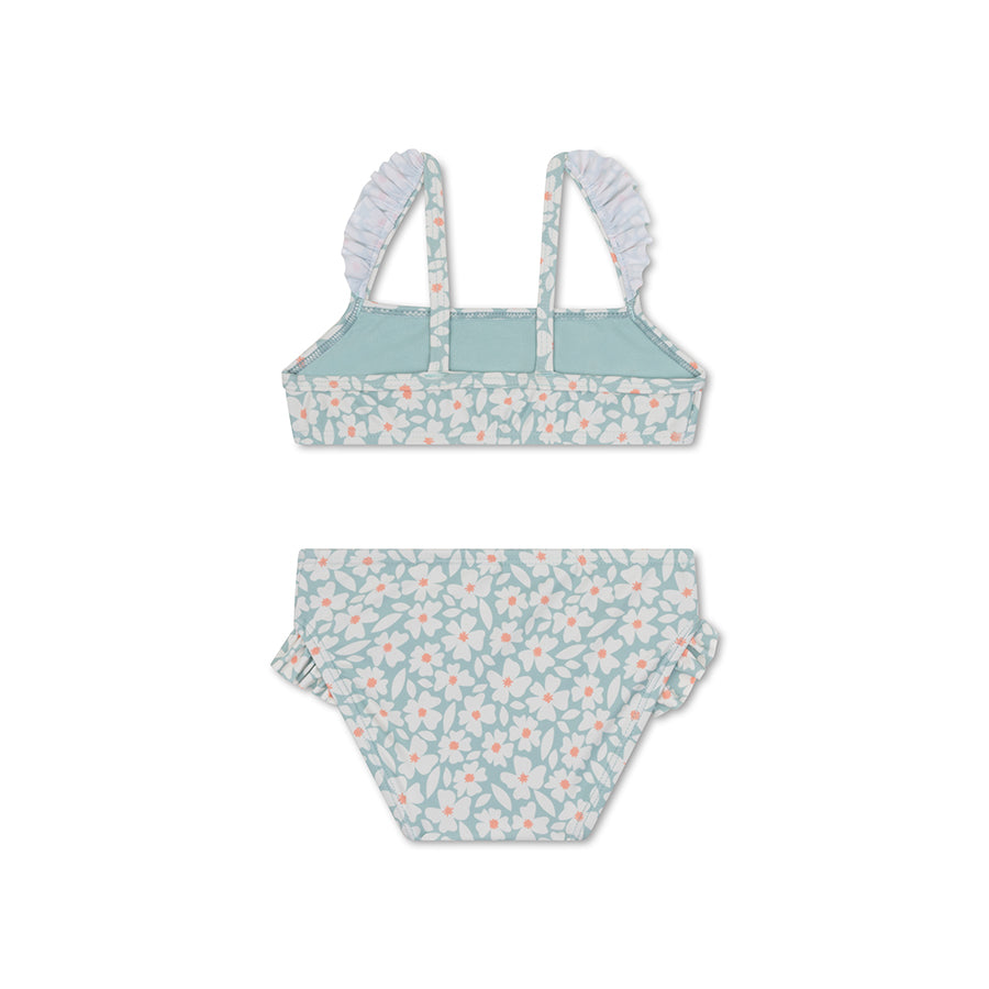 The back of a green bikini with floral pattern on a white background