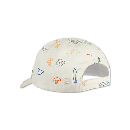 The back of a beige cap with colorful sea patterns on a white background