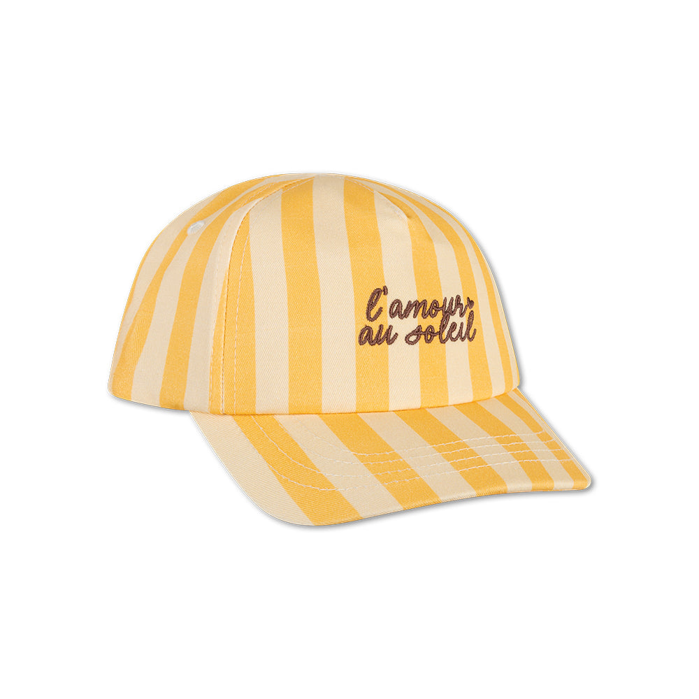 Yellow and beige striped cap with "L'amour au Soleil" text on it on a white background