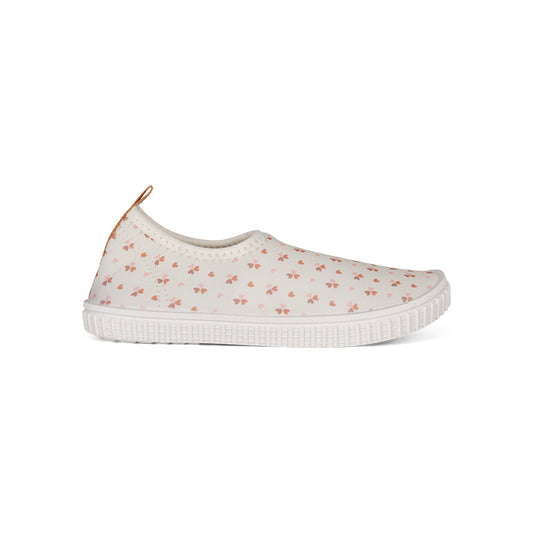 Old pink water shoe with cozy hearts pattern on a white background