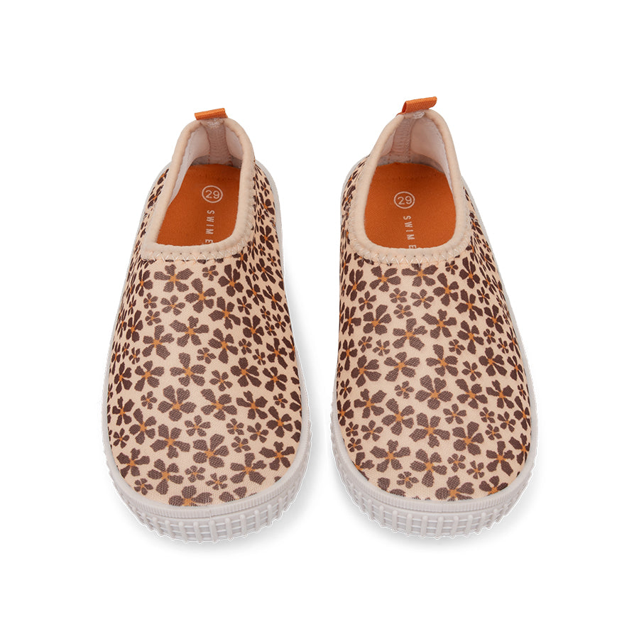 Pair of wild floral-patterned water shoes on a white background