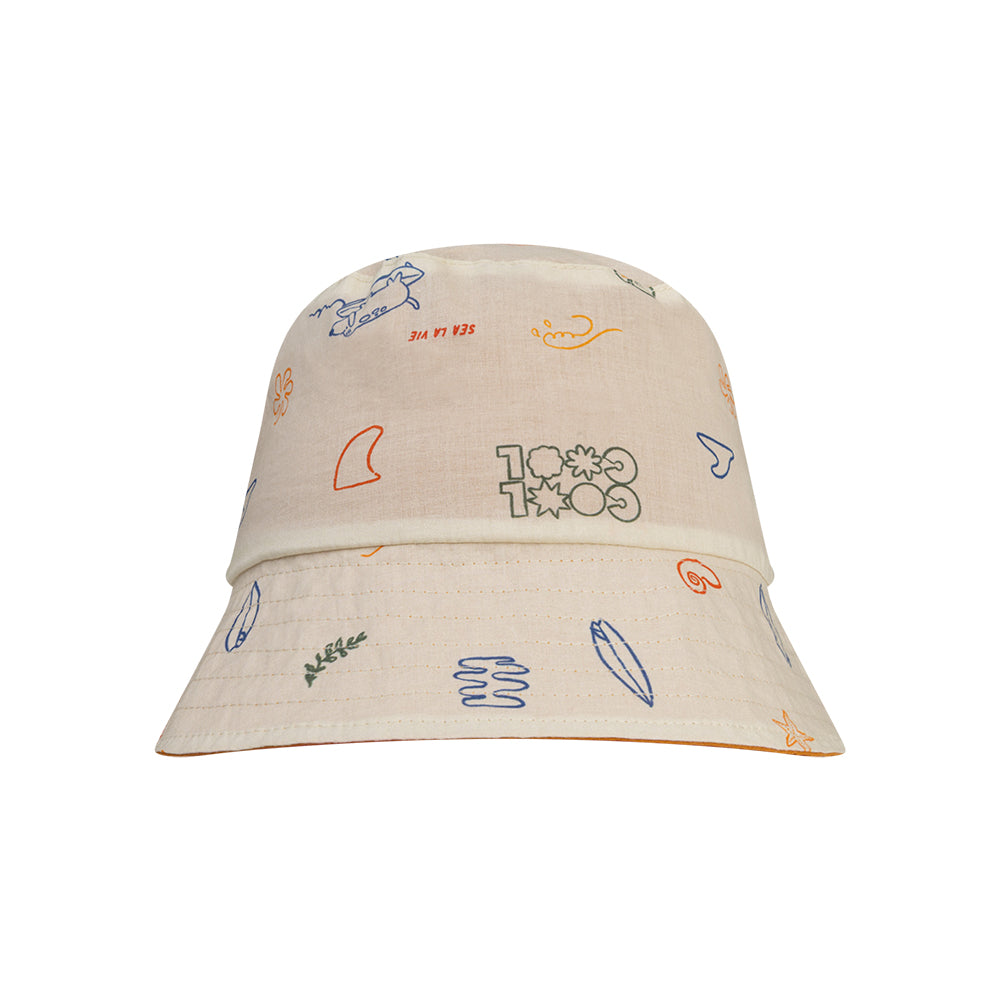 Beige reversible hat with colorful sea patterns on a white background