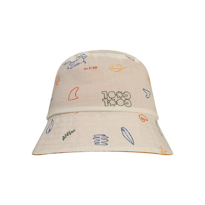 Beige reversible hat with colorful sea patterns on a white background