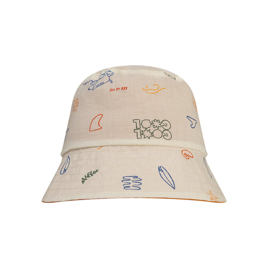 Beige reversible hat with colorful sea patterns on a white background