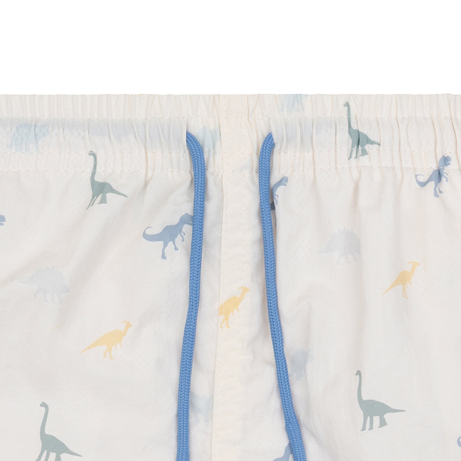 Children's swimshorts with dinosaur pattern and blue drawstring on a light background