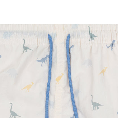 Children's swimshorts with dinosaur pattern and blue drawstring on a light background