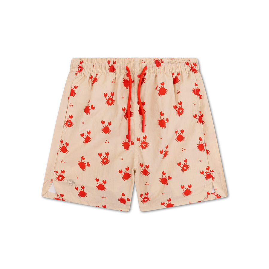 Beige swim shorts with red crab pattern on a white background