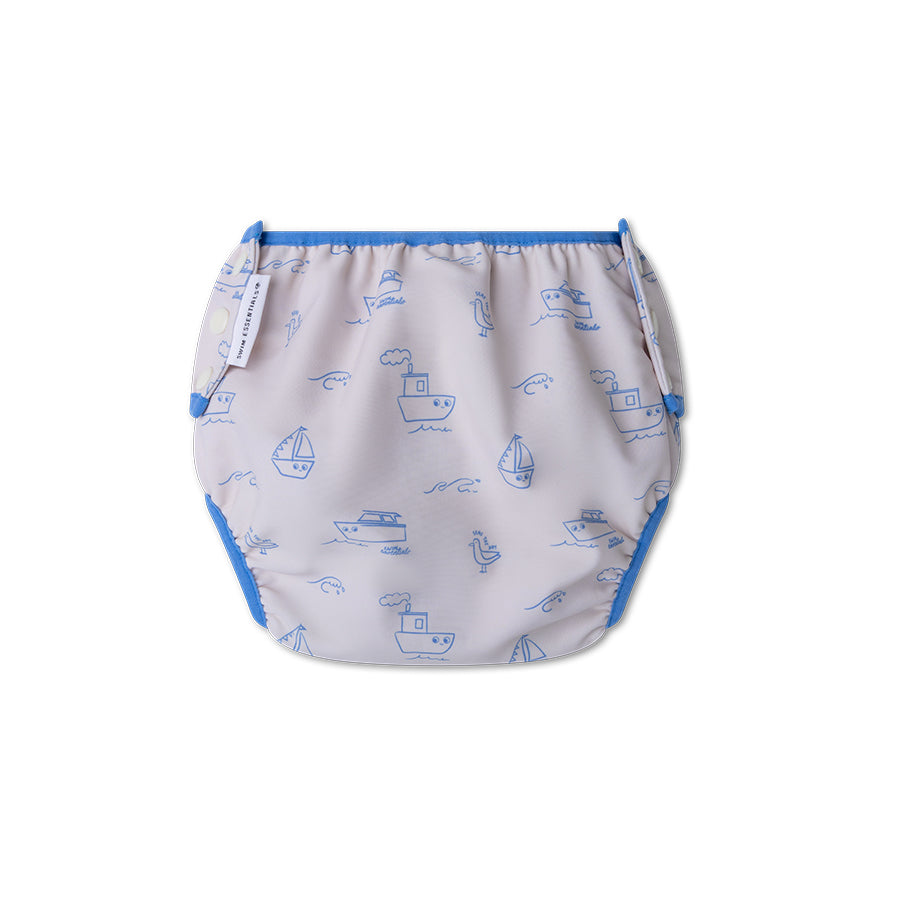 The back of a swim diaper with boat pattern on a white background