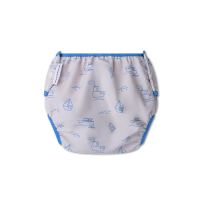 The back of a swim diaper with boat pattern on a white background