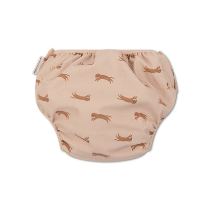 The back of beige swim diaper with animal pattern on a white background
