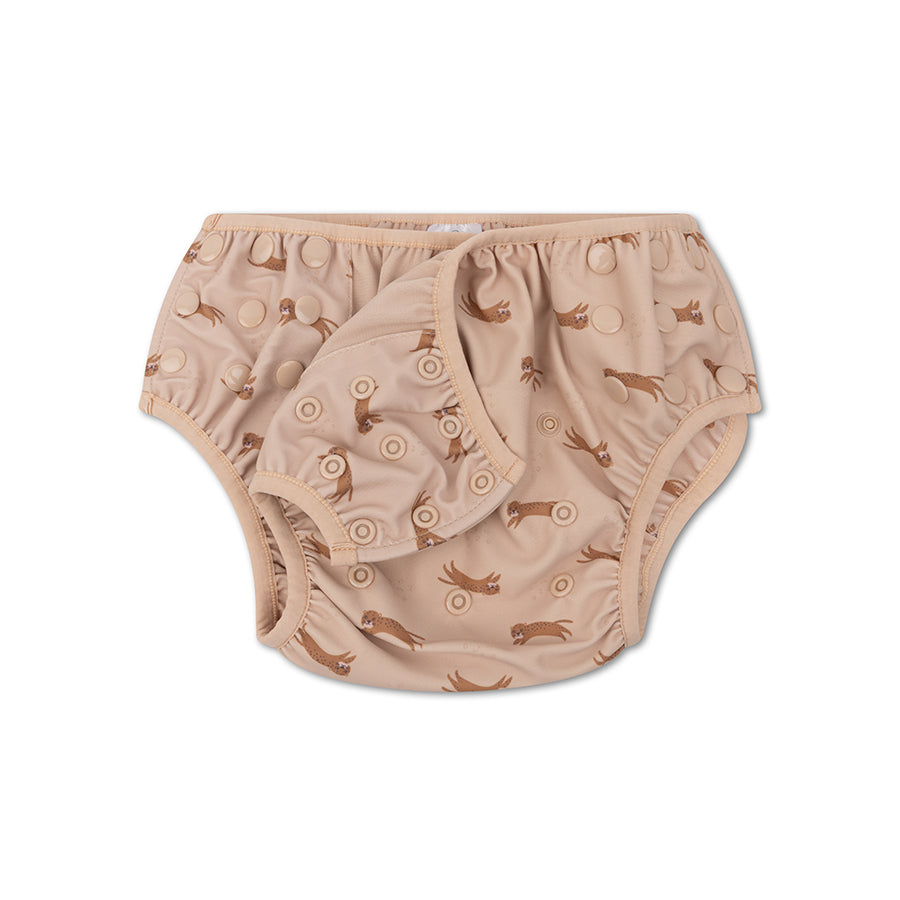 Beige swim diaper with animal pattern on a white background