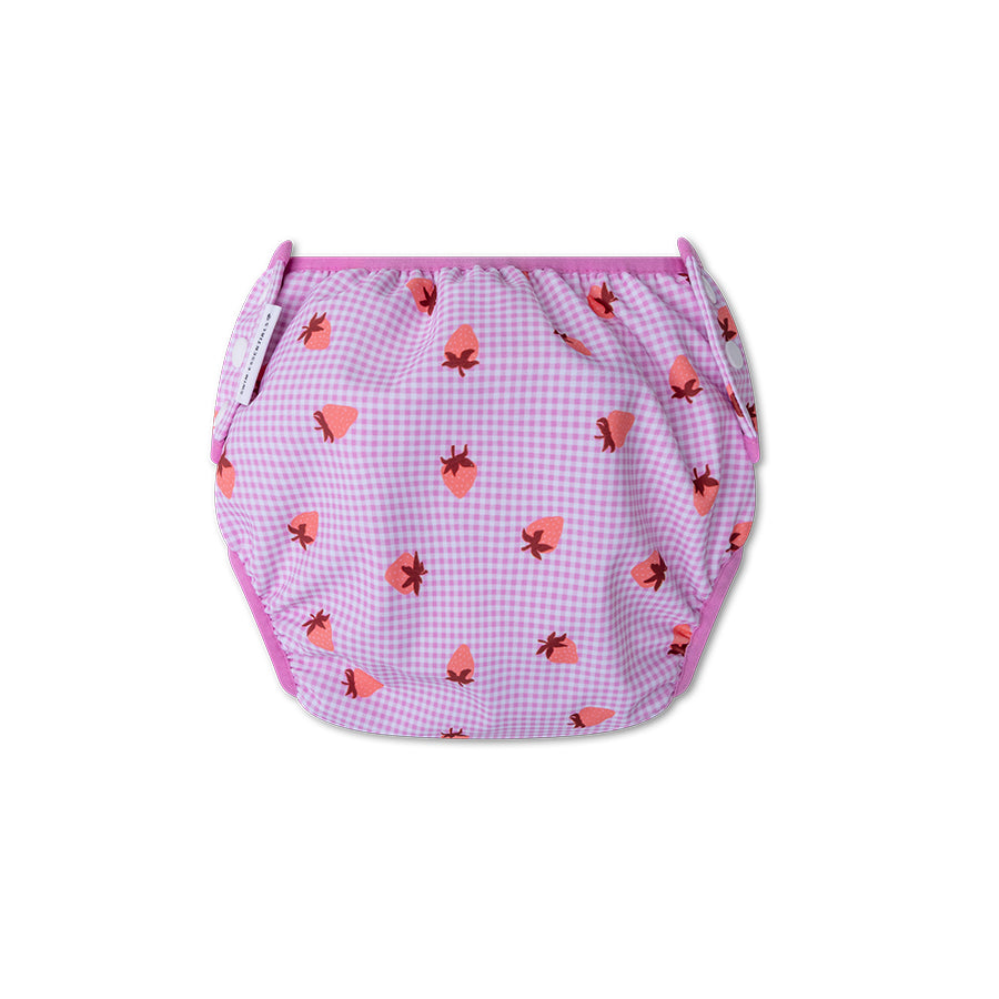 The back of a pink checkered swim diaper with strawberry pattern on a white background
