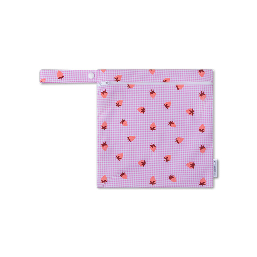 A small pink checkered bag with red heart patterns on a white background