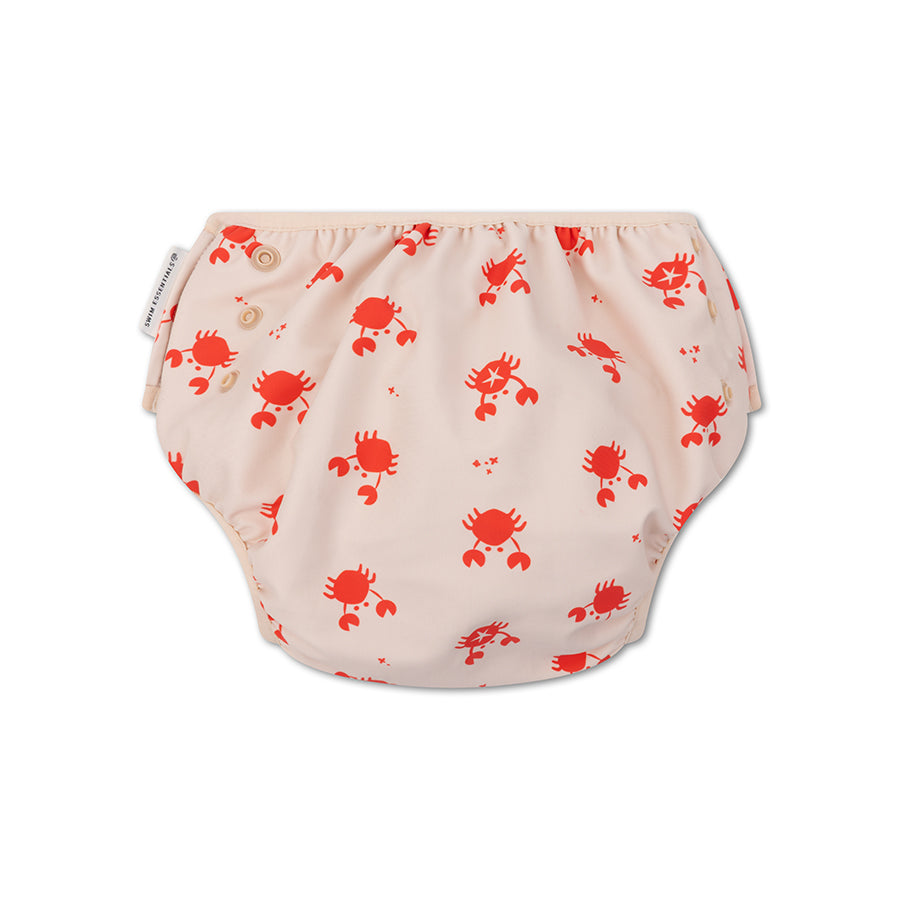 The back of a beige swim diaper with red crab pattern on a white background