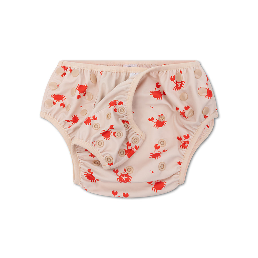 A beige swim diaper with red crab pattern on a white background