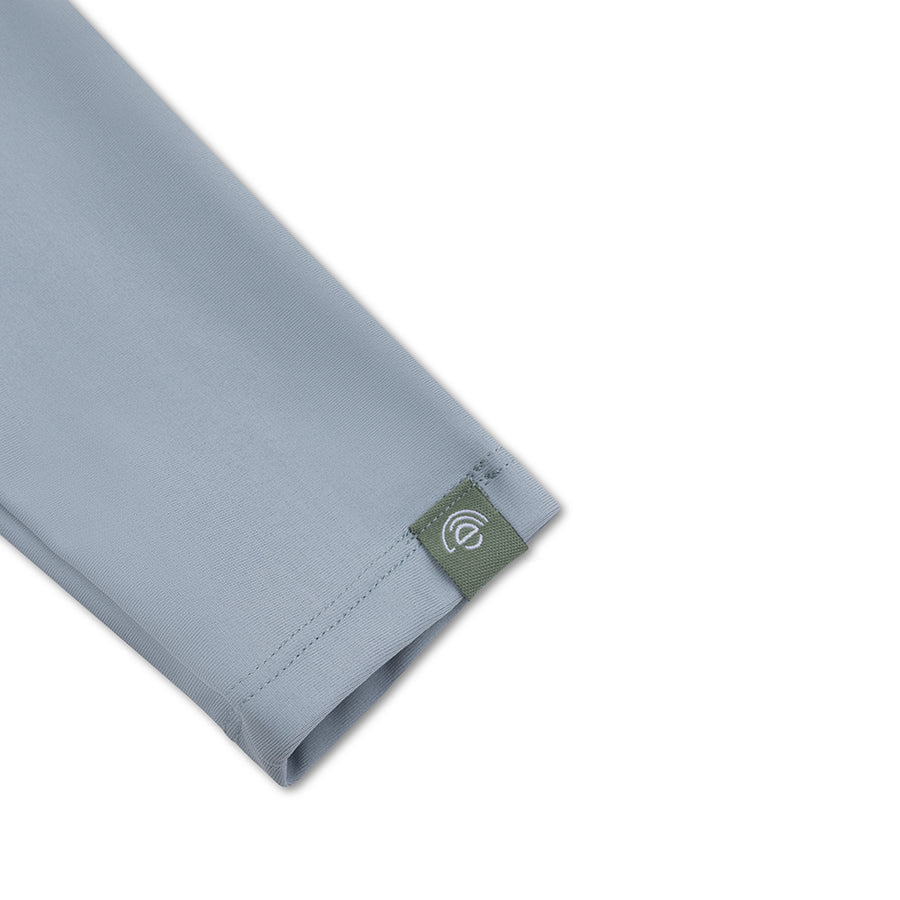 Gray fabric with a green tag and a white Swim Essentials on a white background