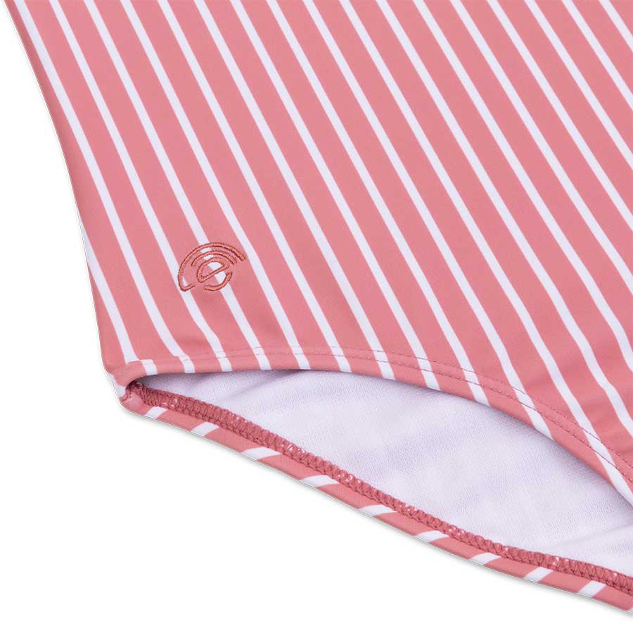 Close-up of a pink and white striped fabric with a logo on a light gray background