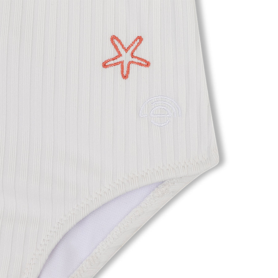 White swimsuit with a red starfish design on a white background