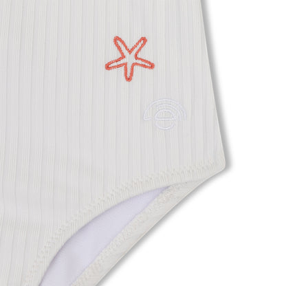 White swimsuit with a red starfish design on a white background