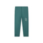 Green UV legging featuring a white logo with surf figures and the text “swim essentials” on it on a white background