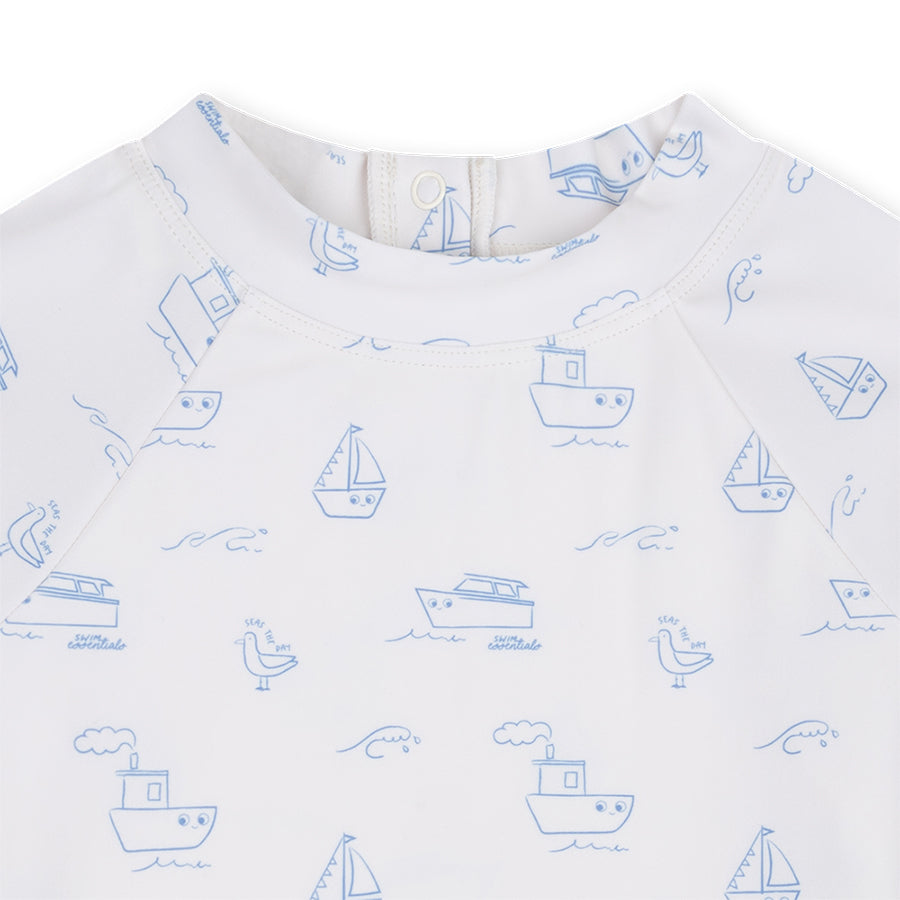 White swim shirt with blue boat pattern on a white background