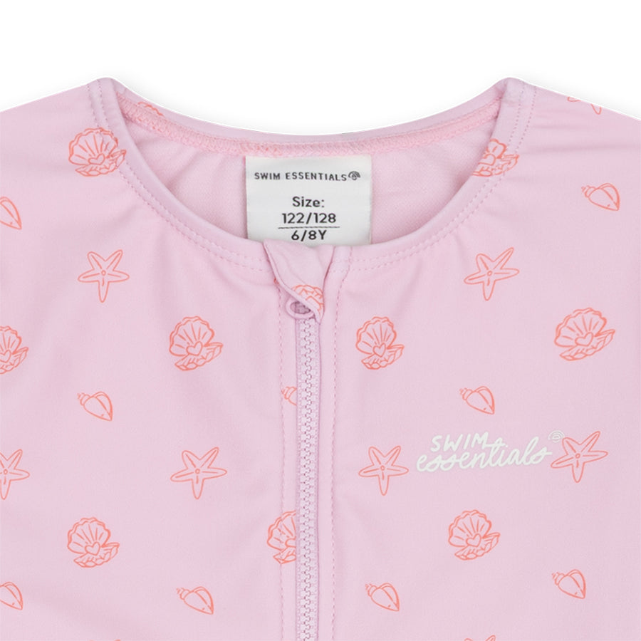 Pink swimwear with shell patterns and a visible brand label on a white background