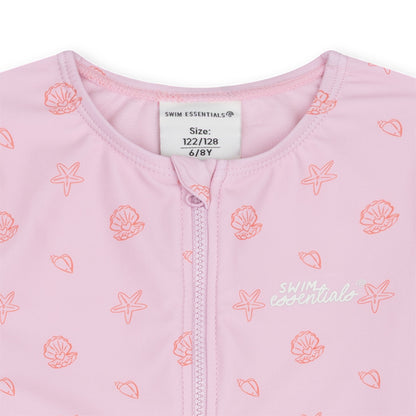 Pink swimwear with shell patterns and a visible brand label on a white background