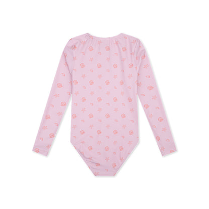 Pink long-sleeve swimsuit Shell Tastic with small orange shell patterns on a white background